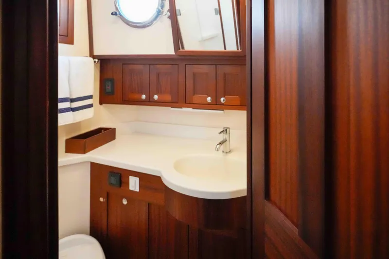 Take 2 Yacht Photos Pics Luxurious bathroom interior of 2015 Nordic Tug 44 yacht with wooden cabinetry and modern fixtures.