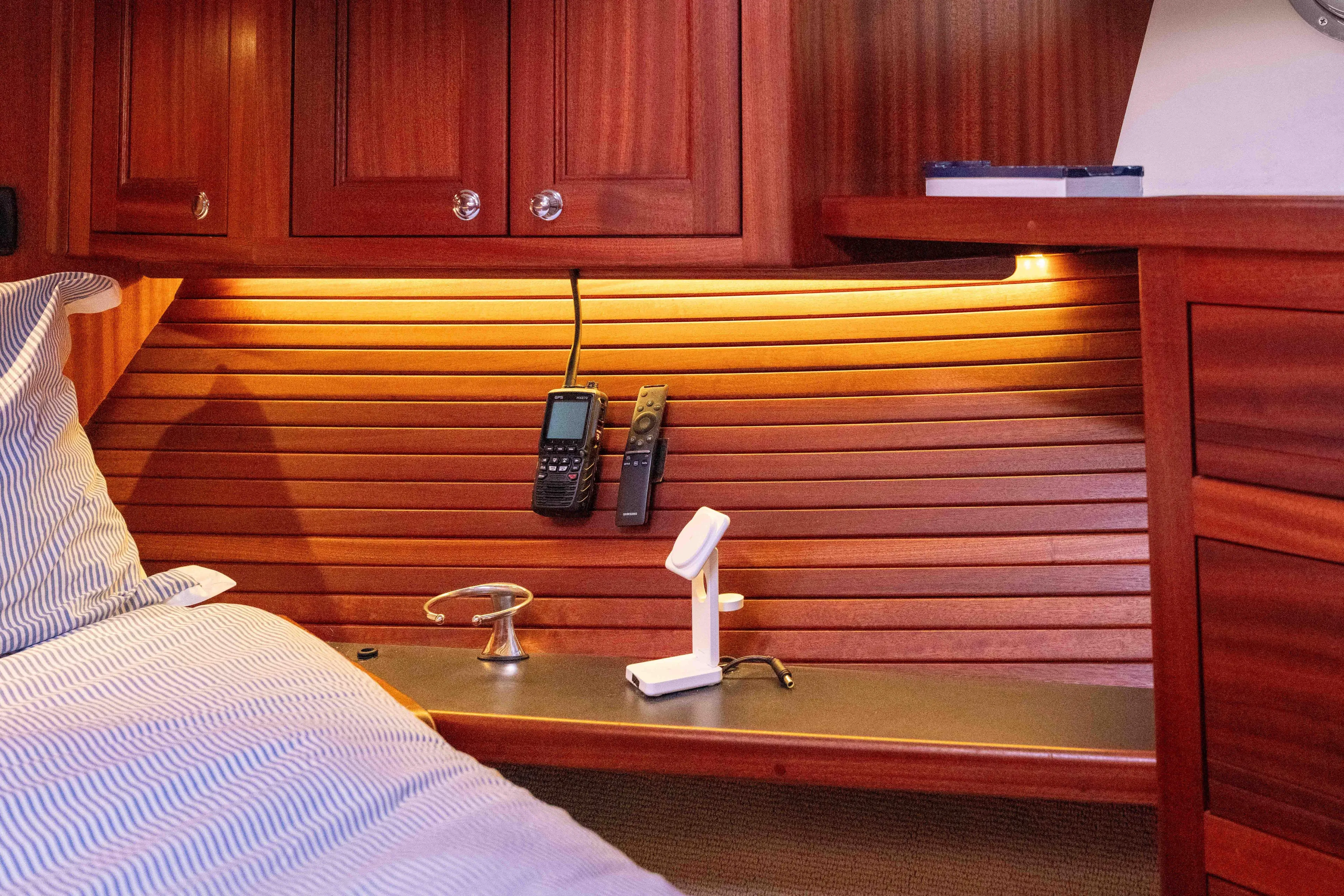 Take 2 Yacht Photos Pics Cozy cabin interior of 2015 Nordic Tug 44 with wood paneling and communication devices.