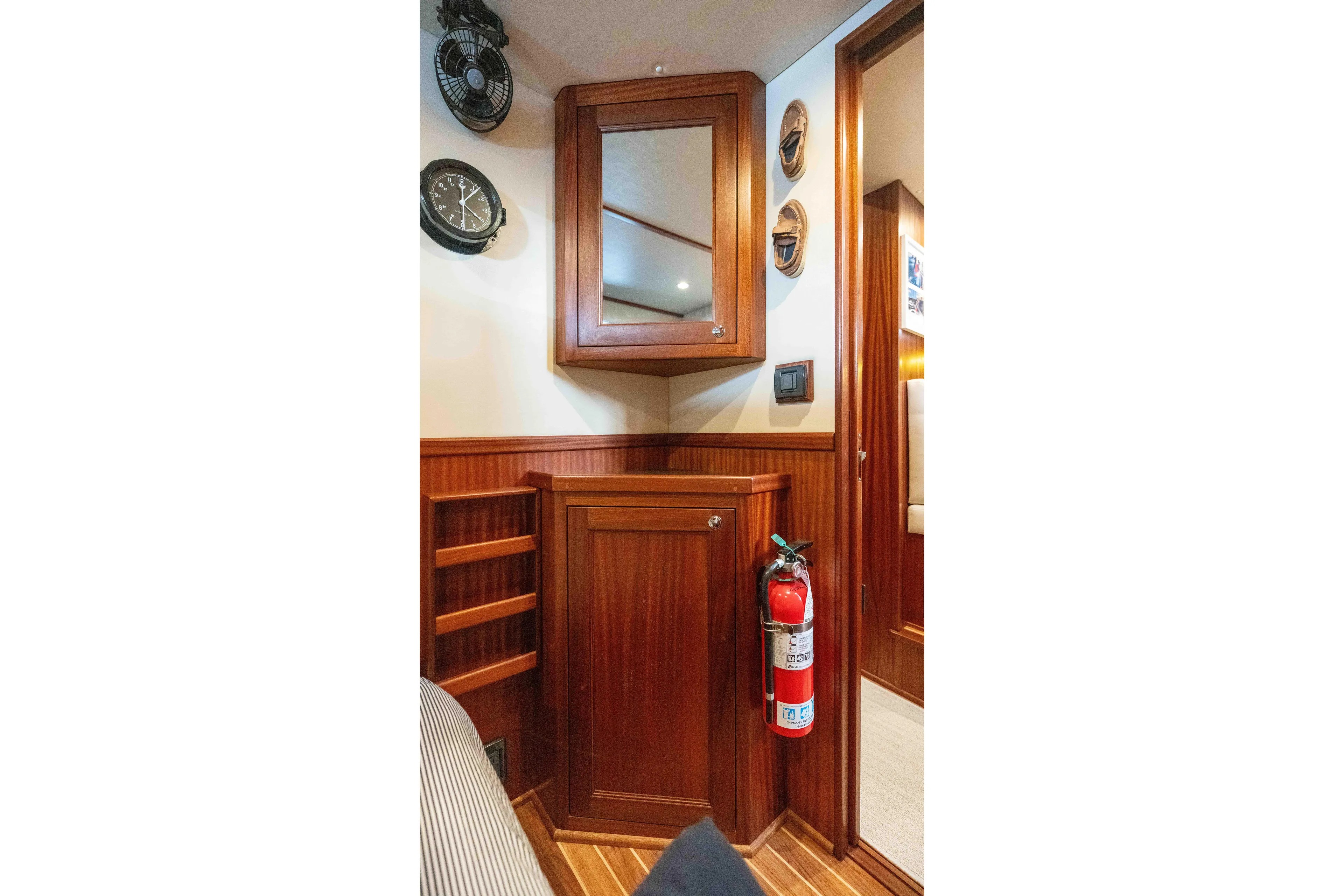 Take 2 Yacht Photos Pics Interior of 2015 Nordic Tug 44 with wooden cabinetry and fire extinguisher.