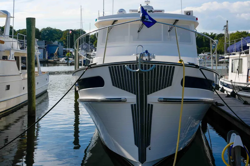 Take 2 Yacht Photos Pics 2015 Nordic Tug 44 docked at marina, front view with clear sky background.