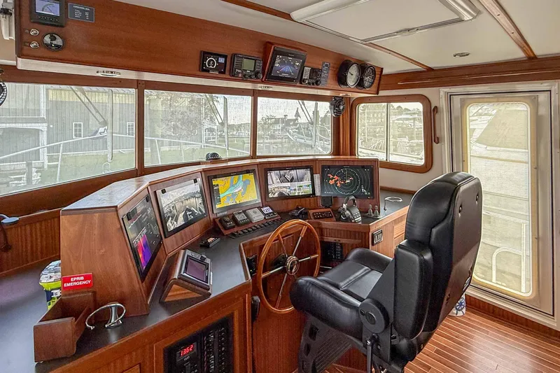 Take 2 Yacht Photos Pics Pilothouse of 2015 Nordic Tug 44 with navigation equipment and captain's chair.