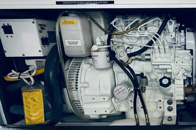 Take 2 Yacht Photos Pics Engine compartment of a 2015 Nordic Tug 44, featuring generator and coolant reservoir.