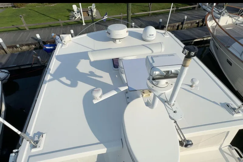 Take 2 Yacht Photos Pics Nordic Tug 44 (2015) boat deck with radar and navigation equipment, docked at marina.