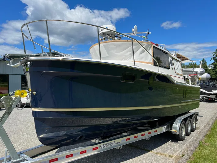  Yacht Photos Pics 2024 Ranger Tugs R-27 boat on trailer, blue hull, sunny day.