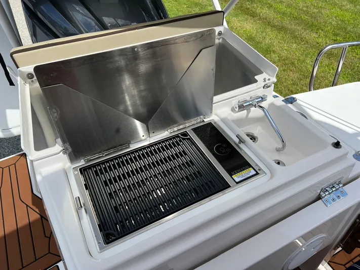  Yacht Photos Pics Outdoor kitchen on 2024 Ranger Tugs R-27 boat with grill and sink.
