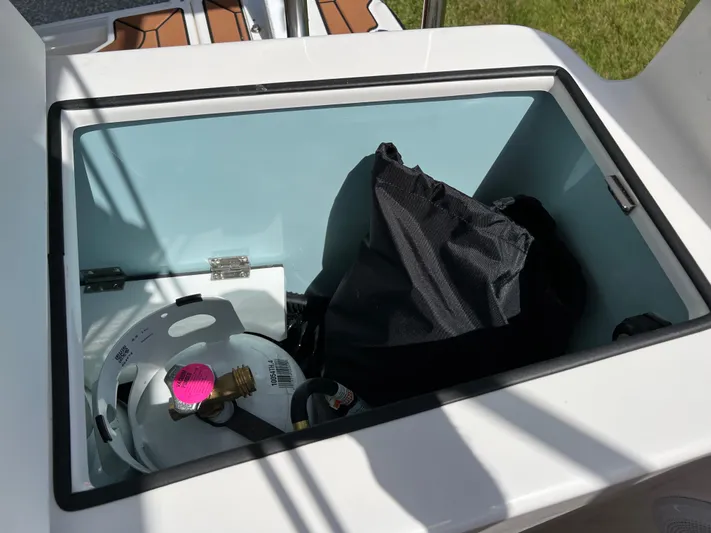  Yacht Photos Pics Storage compartment on 2024 Ranger Tugs R-27 boat with propane tank and bag.