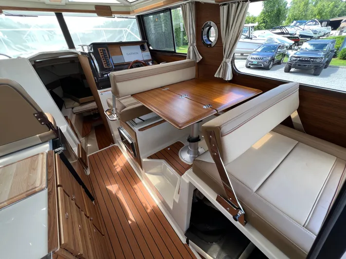  Yacht Photos Pics 2024 Ranger Tugs R-27 interior with wood accents and seating area.
