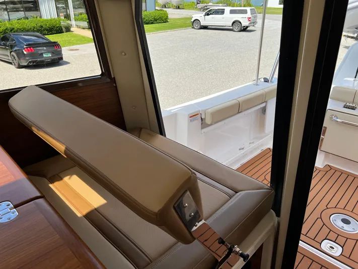  Yacht Photos Pics 2024 Ranger Tugs R-27 interior with tan seating and wooden flooring.