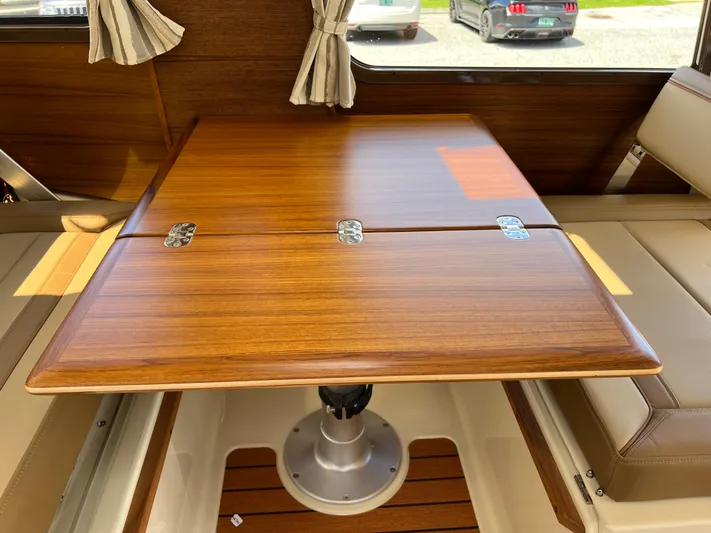  Yacht Photos Pics 2024 Ranger Tugs R-27 interior with wooden table and seating.