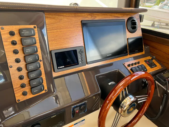  Yacht Photos Pics 2024 Ranger Tugs R-27 dashboard with wood accents and modern navigation controls.