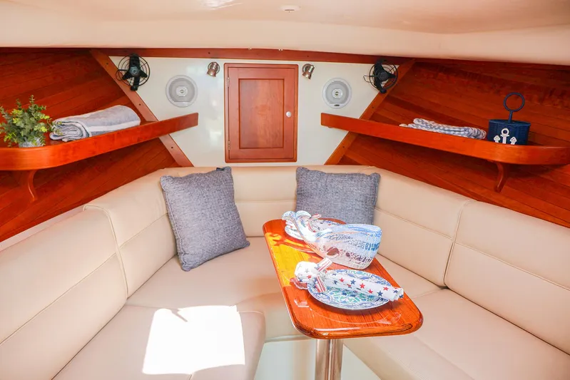 4652tw Yacht Photos Pics Interior of 2007 MJM 29z boat with cozy seating and wooden accents.