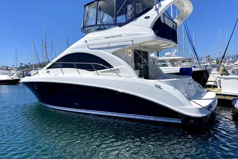 Production Office Yacht Photos Pics 2007 Sea Ray 36 Sedan Bridge yacht docked in a marina under clear blue skies.
