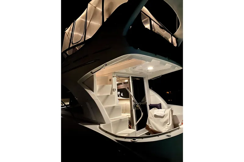 Production Office Yacht Photos Pics 2007 Sea Ray 36 Sedan Bridge yacht illuminated at night, showcasing elegant design and spacious interior.