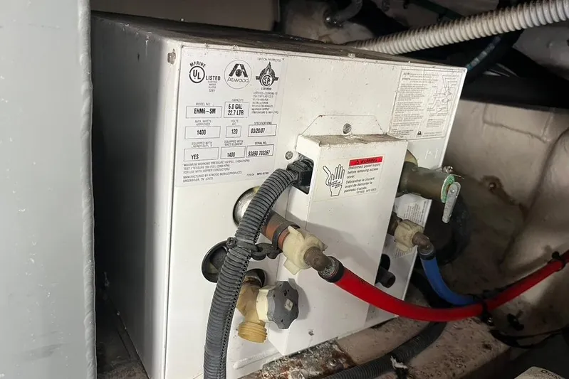 Production Office Yacht Photos Pics Water heater in 2007 Sea Ray 36 Sedan Bridge engine room, showing connections and labels.