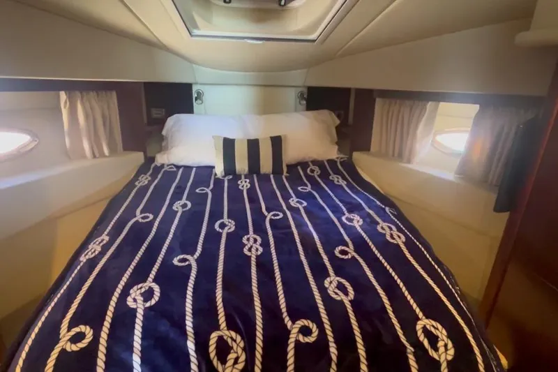 Production Office Yacht Photos Pics Cozy bedroom in 2007 Sea Ray 36 Sedan Bridge yacht with nautical-themed bedding.