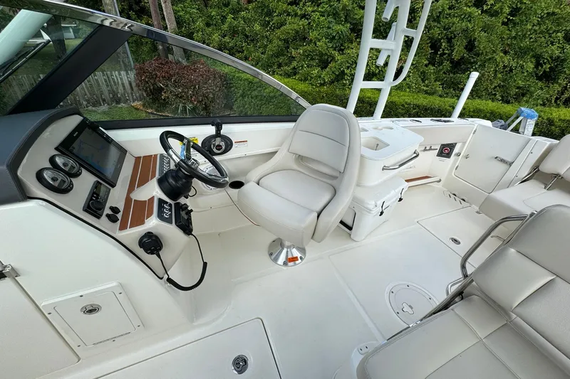  Yacht Photos Pics 2019 Boston Whaler 230 Vantage boat interior with helm, seating, and control panel.