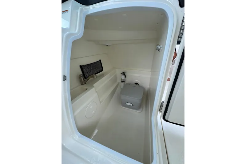  Yacht Photos Pics 2019 Boston Whaler 230 Vantage interior storage compartment with portable toilet and safety equipment.