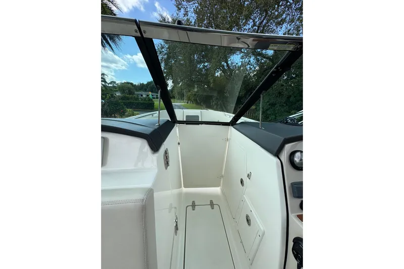  Yacht Photos Pics 2019 Boston Whaler 230 Vantage boat interior with windshield and storage compartments.