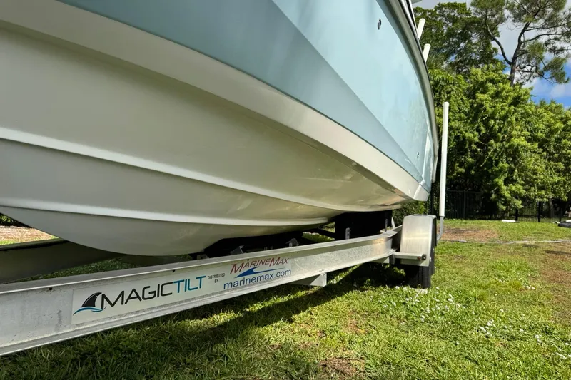  Yacht Photos Pics 2019 Boston Whaler 230 Vantage on Magic Tilt trailer, parked on grass.