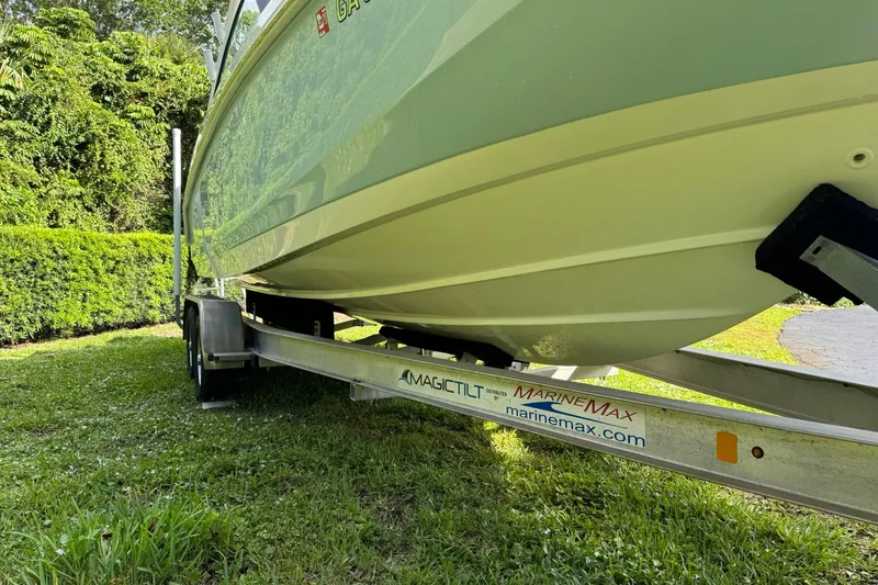  Yacht Photos Pics 2019 Boston Whaler 230 Vantage on trailer, parked on grass, side view.