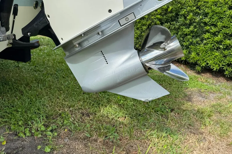  Yacht Photos Pics 2019 Boston Whaler 230 Vantage boat propeller on grassy background.