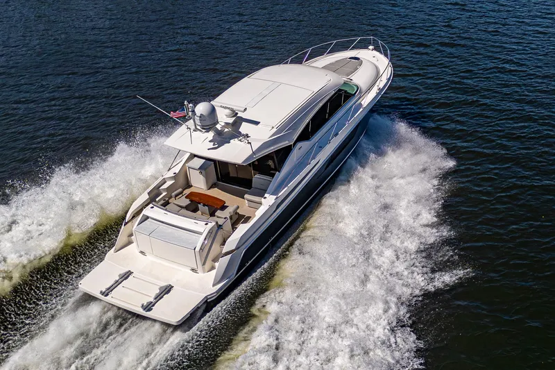  Yacht Photos Pics 2020 Tiara Yachts C53 Coupe cruising on open water, aerial view.