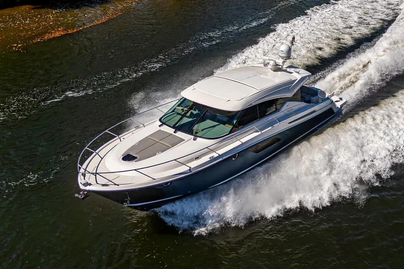 Yacht Photos Pics 2020 Tiara Yachts C53 Coupe cruising on water, showcasing sleek design and performance.