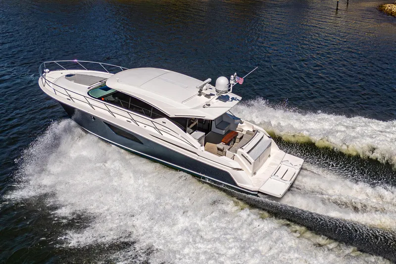  Yacht Photos Pics 2020 Tiara Yachts C53 Coupe cruising on water, aerial view.