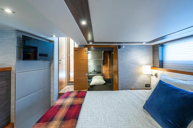  Yacht Photos Pics Luxurious bedroom interior of 2020 Tiara Yachts C53 Coupe with modern decor and cozy bedding.