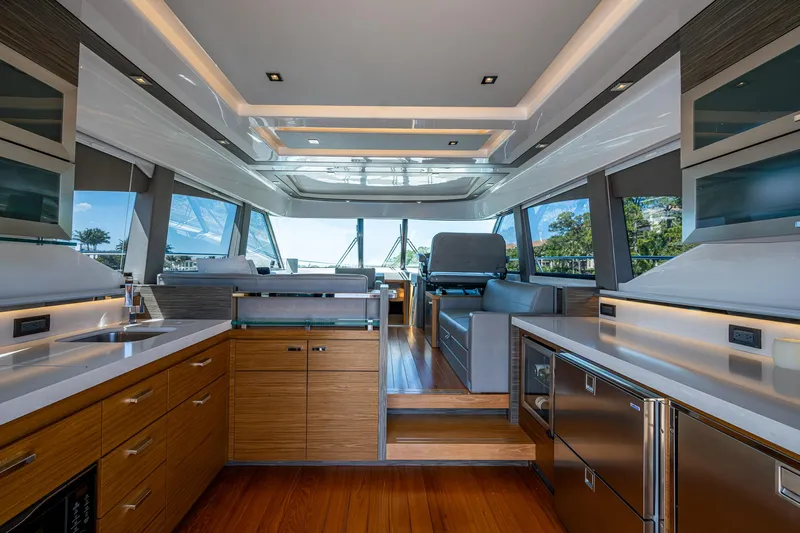  Yacht Photos Pics Luxurious interior of 2020 Tiara Yachts C53 Coupe with modern kitchen and panoramic windows.