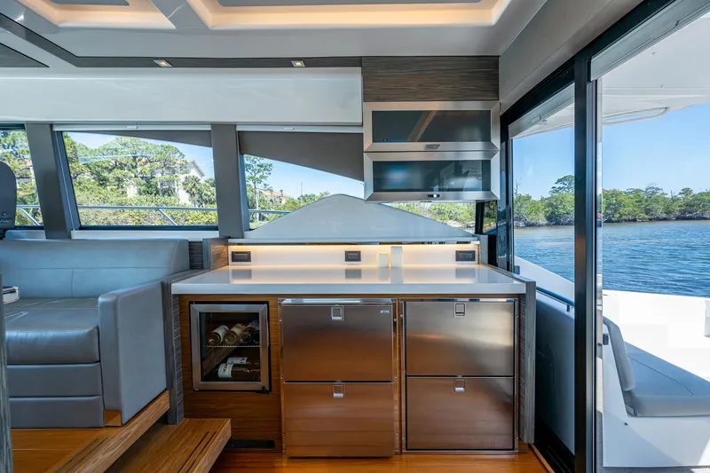  Yacht Photos Pics Interior of 2020 Tiara Yachts C53 Coupe, featuring modern kitchen and scenic water view.