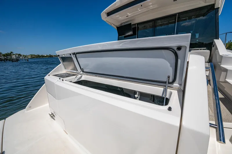  Yacht Photos Pics 2020 Tiara Yachts C53 Coupe, open deck compartment, sunny day, waterfront view.