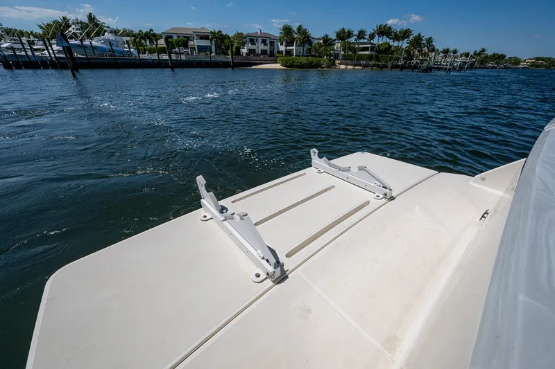  Yacht Photos Pics 2020 Tiara Yachts C53 Coupe swim platform on calm water, with scenic waterfront view.