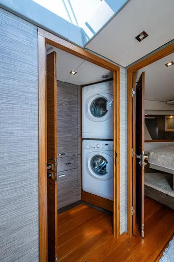  Yacht Photos Pics 2020 Tiara Yachts C53 Coupe interior with stacked washer and dryer.