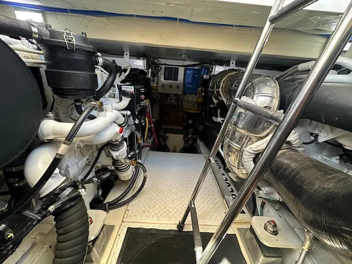  Yacht Photos Pics Engine room of 2020 Tiara Yachts C53 Coupe, showcasing mechanical components and ladder access.