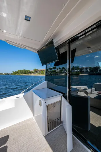  Yacht Photos Pics 2020 Tiara Yachts C53 Coupe, outdoor deck view with TV and ocean backdrop.