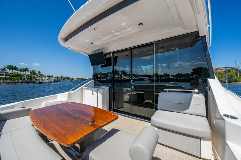  Yacht Photos Pics 2020 Tiara Yachts C53 Coupe, elegant outdoor seating, scenic waterfront view.