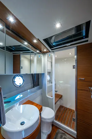  Yacht Photos Pics Luxurious bathroom in 2020 Tiara Yachts C53 Coupe with modern fixtures and wooden accents.