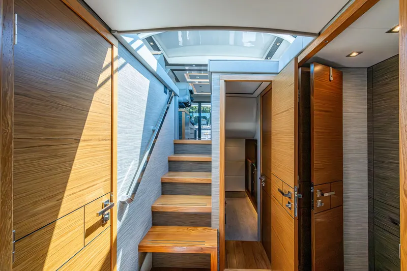  Yacht Photos Pics Interior of 2020 Tiara Yachts C53 Coupe with wooden stairs and modern design.