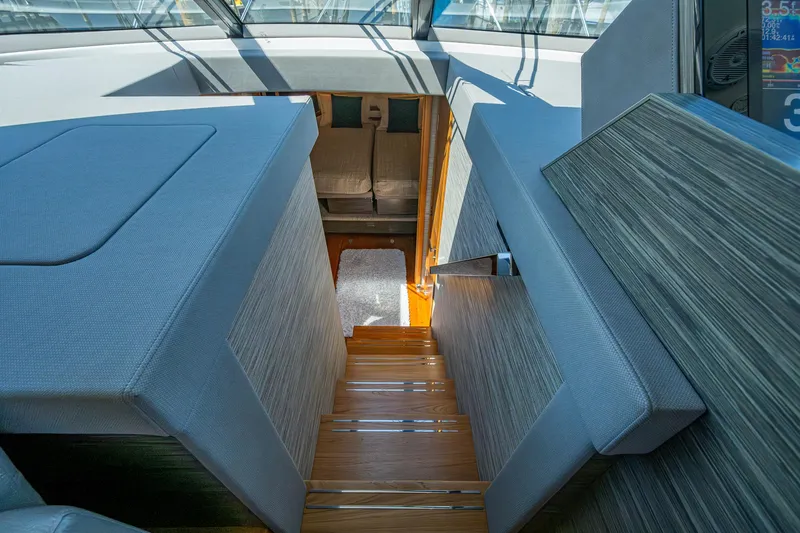  Yacht Photos Pics Interior view of 2020 Tiara Yachts C53 Coupe, featuring modern stairs and seating.