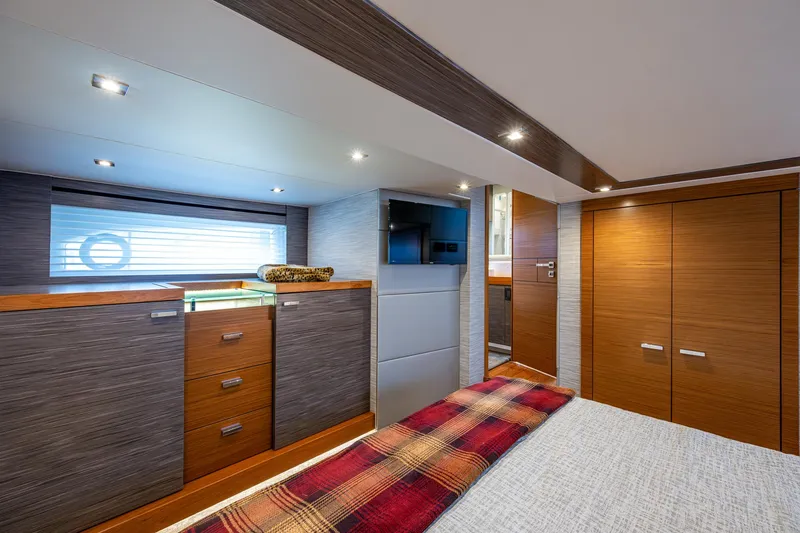  Yacht Photos Pics 2020 Tiara Yachts C53 Coupe interior cabin with modern wood finishes and cozy bedding.