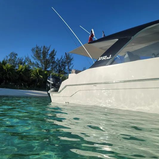 Cat40 Yacht Photos Pics 2022 Catamaran PRJ Cat40 anchored near tropical beach with clear blue water.