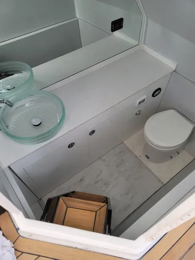 Cat40 Yacht Photos Pics Modern bathroom in 2022 Catamaran PRJ Cat40 with glass sink and compact toilet.