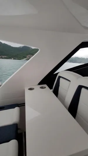 Cat40 Yacht Photos Pics Interior of 2022 Catamaran PRJ Cat40 with sleek seating and table, overlooking water.