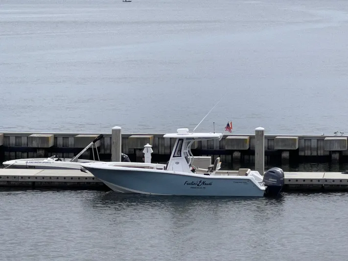  Yacht Photos Pics 2022 Tidewater 256 LXF boat docked at marina, calm water background.