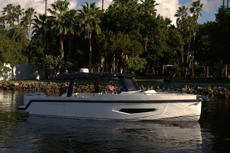  Yacht Photos Pics Modern Fabbro F33 boat cruising on a serene lake, surrounded by lush greenery, 2026 model.