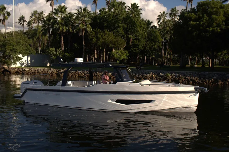  Yacht Photos Pics Modern Fabbro F33 boat cruising on a serene waterway, surrounded by lush greenery, 2026 model.