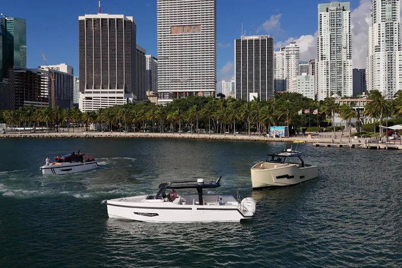  Yacht Photos Pics Boats cruising near a city skyline, featuring the 2026 Fabbro F33 model.