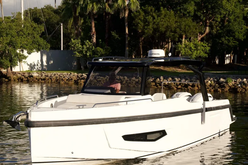  Yacht Photos Pics 2026 Fabbro F33 boat cruising on a calm river, surrounded by lush greenery.