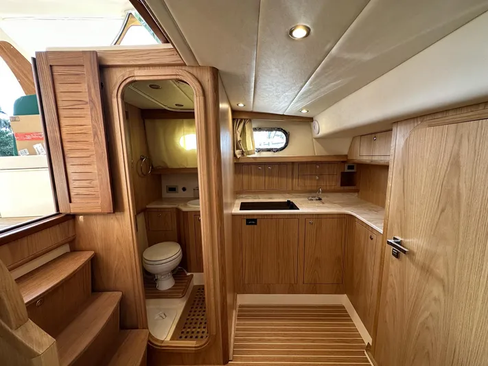 Fratelli Aprea Sorrento 32 Yacht Photos Pics 2023 Fratelli Aprea Sorrento Cabinatto 32 interior with wooden cabinetry and compact kitchen.